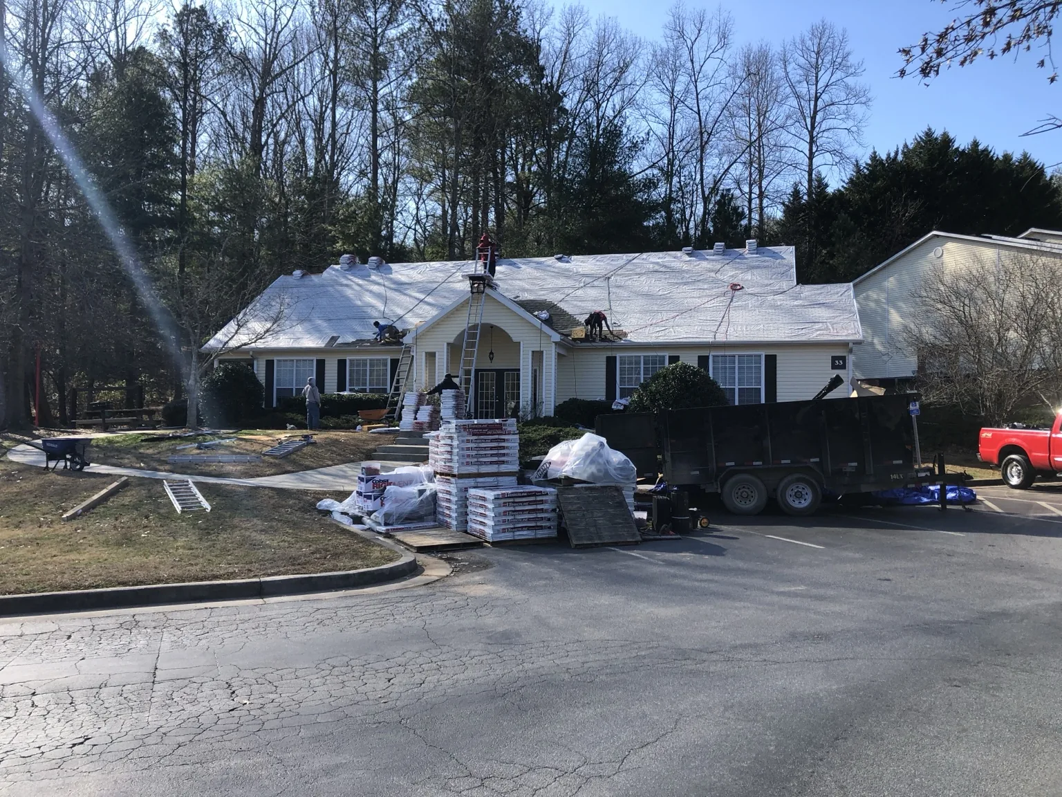 Genesis Roofing crew working on a roof installation