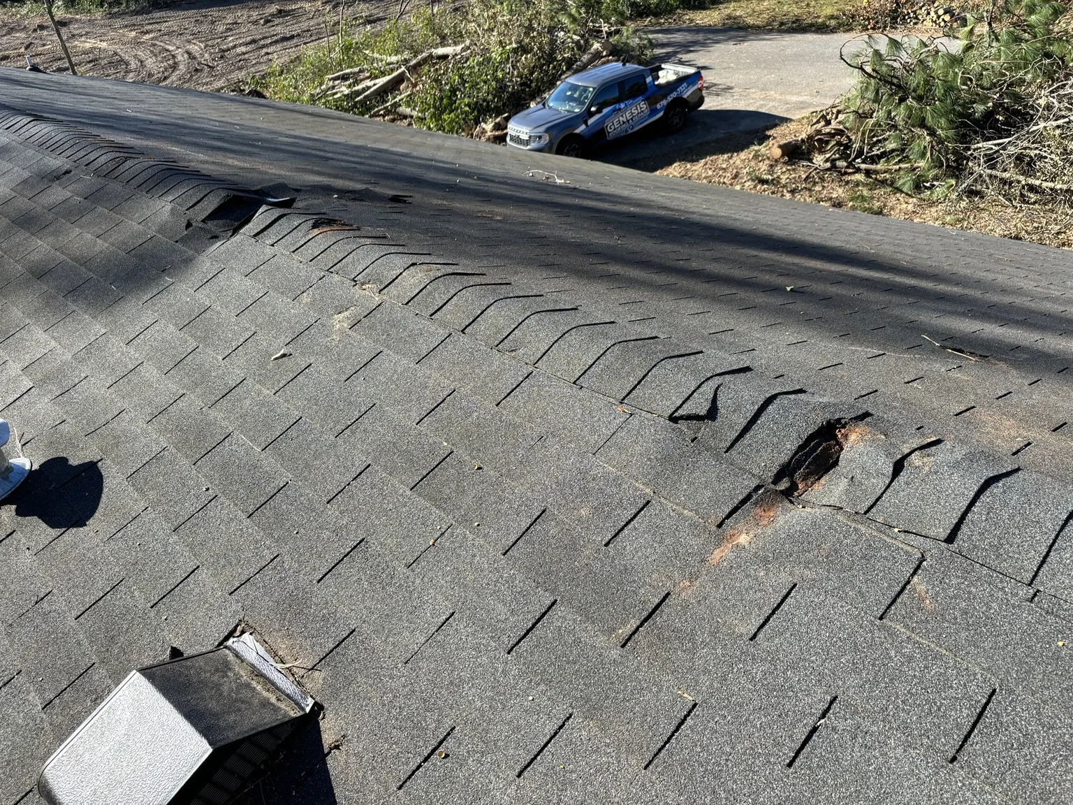 Roof damage inspected before a residential roof replacement