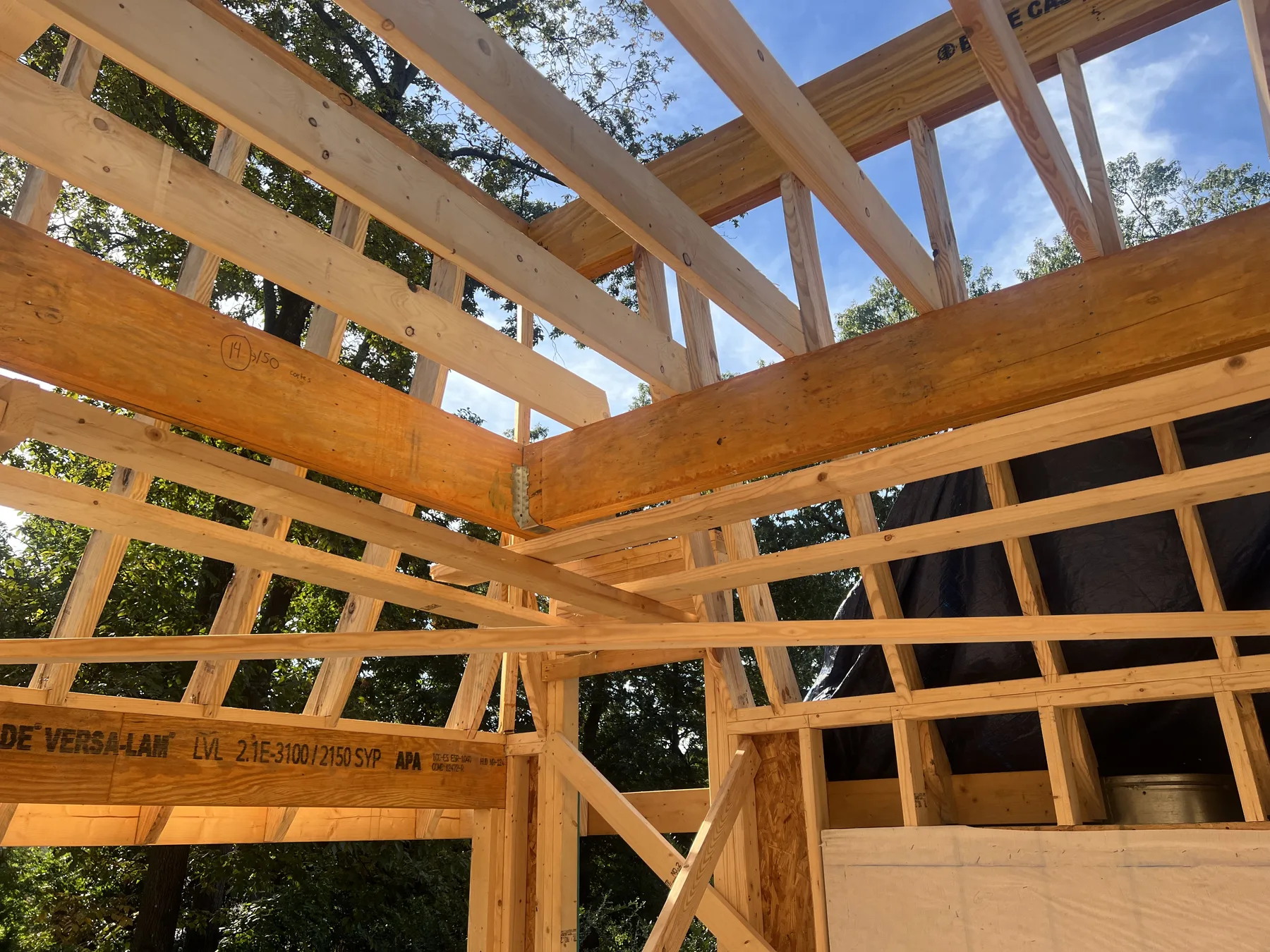 Construction photo showing framing stage of custom roof detail