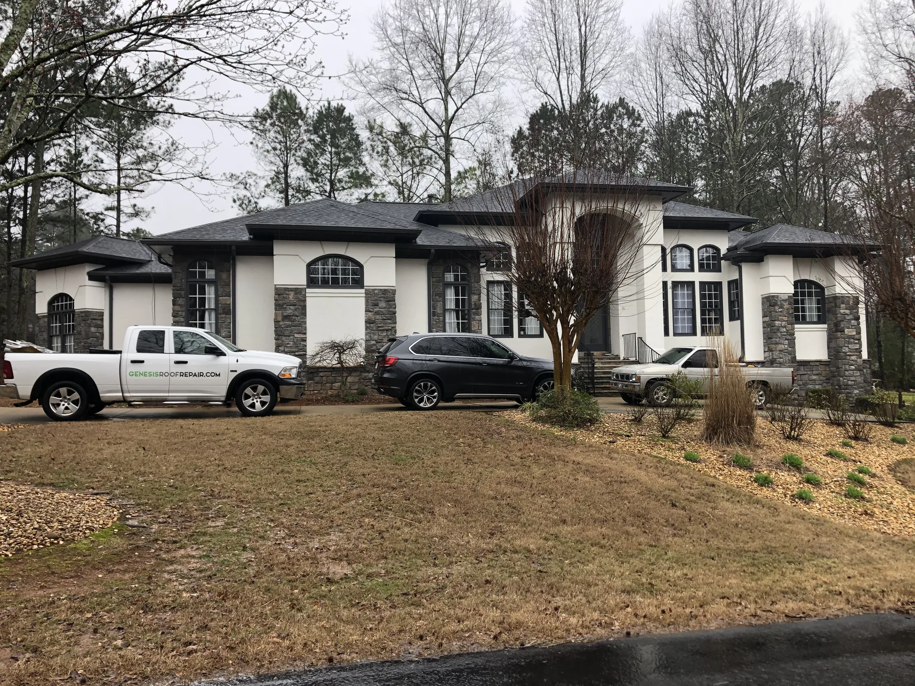 Large white home with dark shingle roof