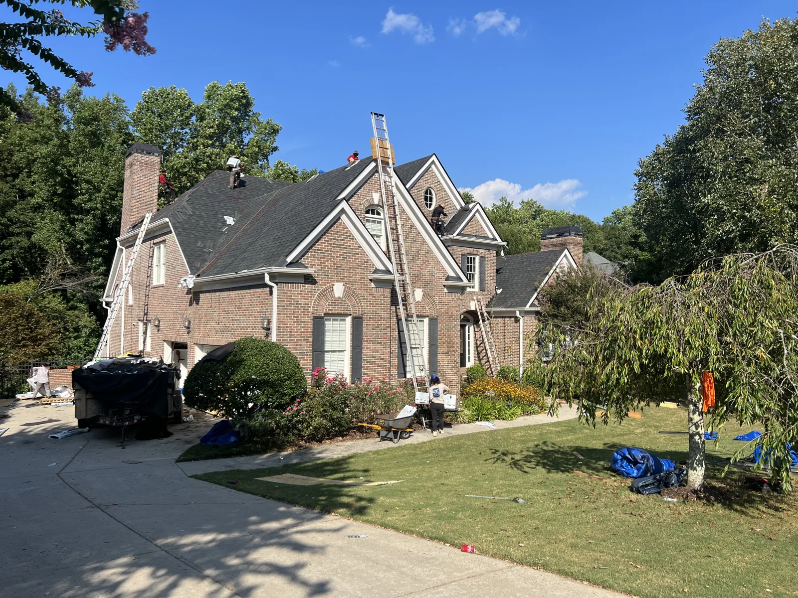 Roofing crew working on a brick home