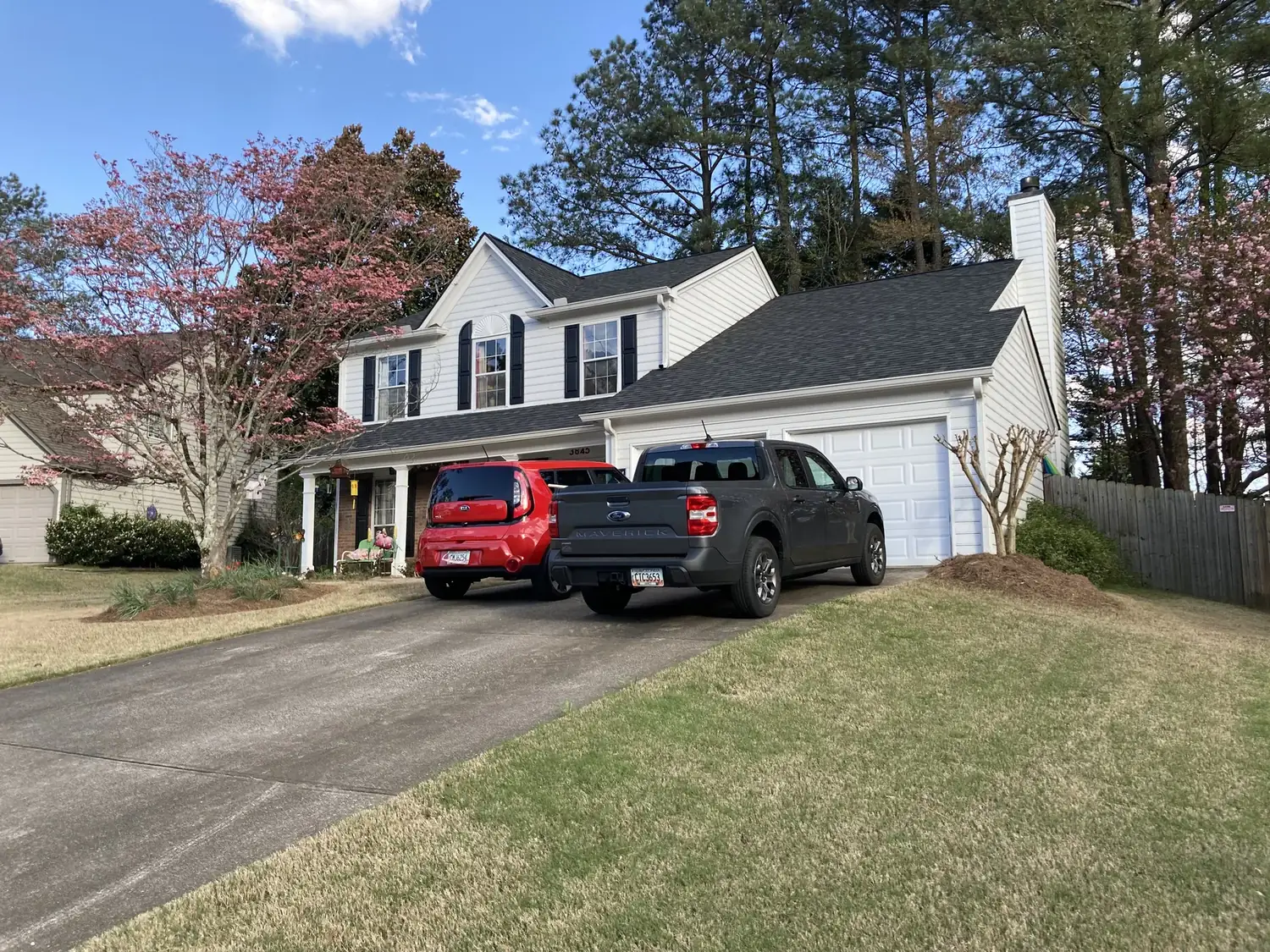 Suwanee roof; parked vehicles obscure part of the house roofing project